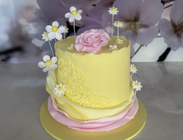 Double height cake with ruffles, piping and flowers