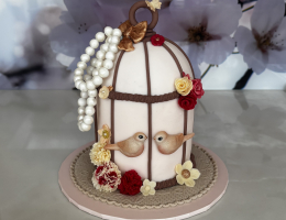Bird cage cake with pearls, flowers and leaves